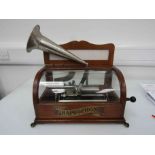 A Columbia coin operated phonograph, c.1900, with glass and oak case and aluminium conical horn.
