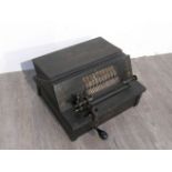 A Gem Roller Organ in gilt printed black case. 37cm wide.