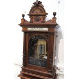 A walnut cased coin-in-the-slot upright Polyphon in original case with storage base,