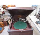 An HMV cabinet gramophone with records in the storage