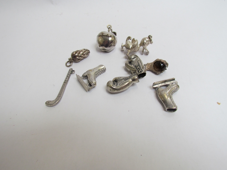 A quantity of white metal bracelet charms including boxing gloves,