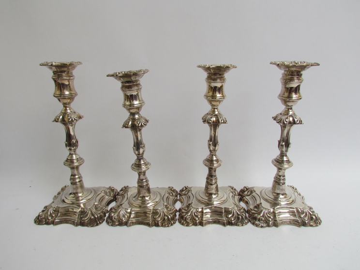 A matched set of four Creswick & Co cast silver candlesticks in the mid 18th Century taste,