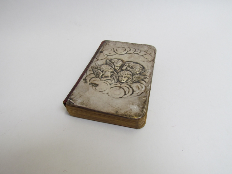 A silver fronted Common Prayer book with cherub deatil, body of book detached from spine,