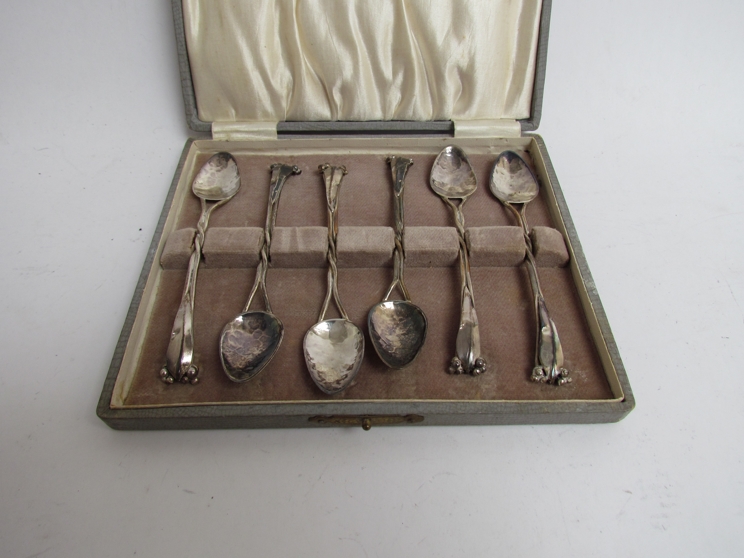 A set of six "Mildred Creed" Australian Arts & Crafts Movement spoons with eucalyptus leaf finials,