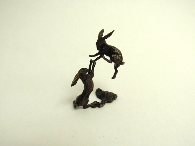 A miniature pair of bronze Boxing Hares,