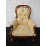 A Victorian style carved mahogany doll's chair in light gold floral button back upholstery