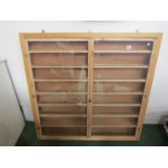 A pine two door display cabinet