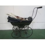 A Victorian wrought iron and painted wooden coach built dolls pram with leather lining and canopy