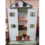 A three storey dolls house and some furniture