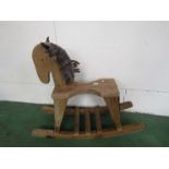 A carved pine rocking horse on bowed rocker