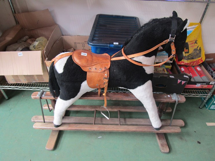 A black and white rocking horse on trestle rocker