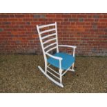 A white painted rocking chair