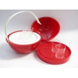 A Guzzini ball shaped picnic set in ted and white plastic designed in 1960's by Helen Panton