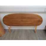 An Ercol double bed headboard