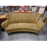 A 1940's Danish curved sofa, original embossed mustard fabric upholstery, stained tapering legs,