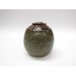 A studio pottery vase with olive green and tenmoku glazes, incised line detail, impressed seal, 15.