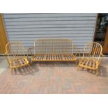 An Ercol light elm Windsor three piece suite