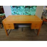 A Danish light oak double pedestal desk with four drawers raised on squared legs,