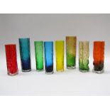 A group of eight Japanese glass bud vases in various colours, cylindrical and squared forms.