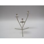 A white metal three sconce candle holder