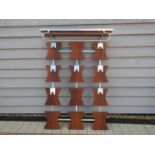 A wall hanging wood and metal coat rack