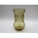 A continental moulded glass vase in amber with stylised creatures and stonework detail.