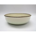 A studio pottery large bowl with pale green and white glazes.