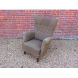 A 1940's Danish winged high back armchair, original olive green upholstery,