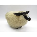 A 1960's sheep skin sheep stool,