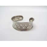 A mid to late 20th Century sterling silver bangle with Zig Zag engraving ,