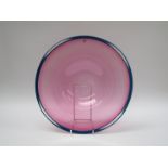 STUART AKROYD (XX/XXI) A large contemporary signed studio art glass dish in pink with blue rim.