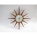 A Smiths teak starburst wall clock. 48.