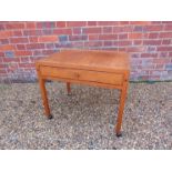 A Danish teak low work table on castors, fitted single drawer, 61.