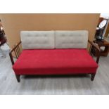 A 1940's Danish dark stained beech framed day bed with original red,