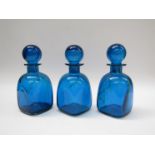 Three unmarked Mdina glass decanters, deep blue with green swirls,