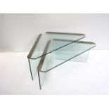 A nest of two glass and chrome tables of triangular form with metal strip detailing