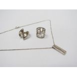 A collection of modernist silver jewellery including two rings and a pendant,