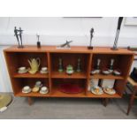 A Danish teak sectional open bookcase raised on tapering legs,