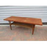 A Danish teak rectangular coffee table raised on "V" shaped legs, undertier, 150.