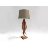 A teak and metal rod table lamp base of organic form,