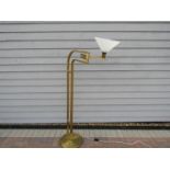 A mid 20th Century brassed standard lamp with white glass conical shade on adjustable arm.