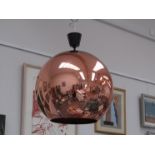 A large copper coloured perspex globe ceiling light by Tom Dixon,