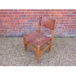 A Danish stained beech framed chair with leather sling seat and back rest