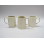 Three Wedgwood white glazed tankards by Keith Murray, 12.5cm high.