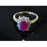 An 18ct gold ruby and diamond ring the central emerald cut ruby framed by diamonds, size O/P, 4.