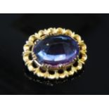 An amethyst brooch with pierced yellow metal mount