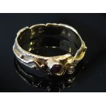 A gold ruby and diamond set dress ring with wavy design, stamped 750, size K/L, 3.