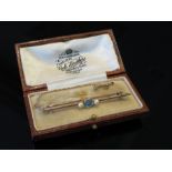 A gold bar brooch with central aquamarine flanked by pearls, stamped 15, in fitted case, 3.