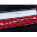 A gold fancy link bracelet with cabochon garnets,