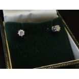 A pair of 9ct white gold diamond stud earrings, .